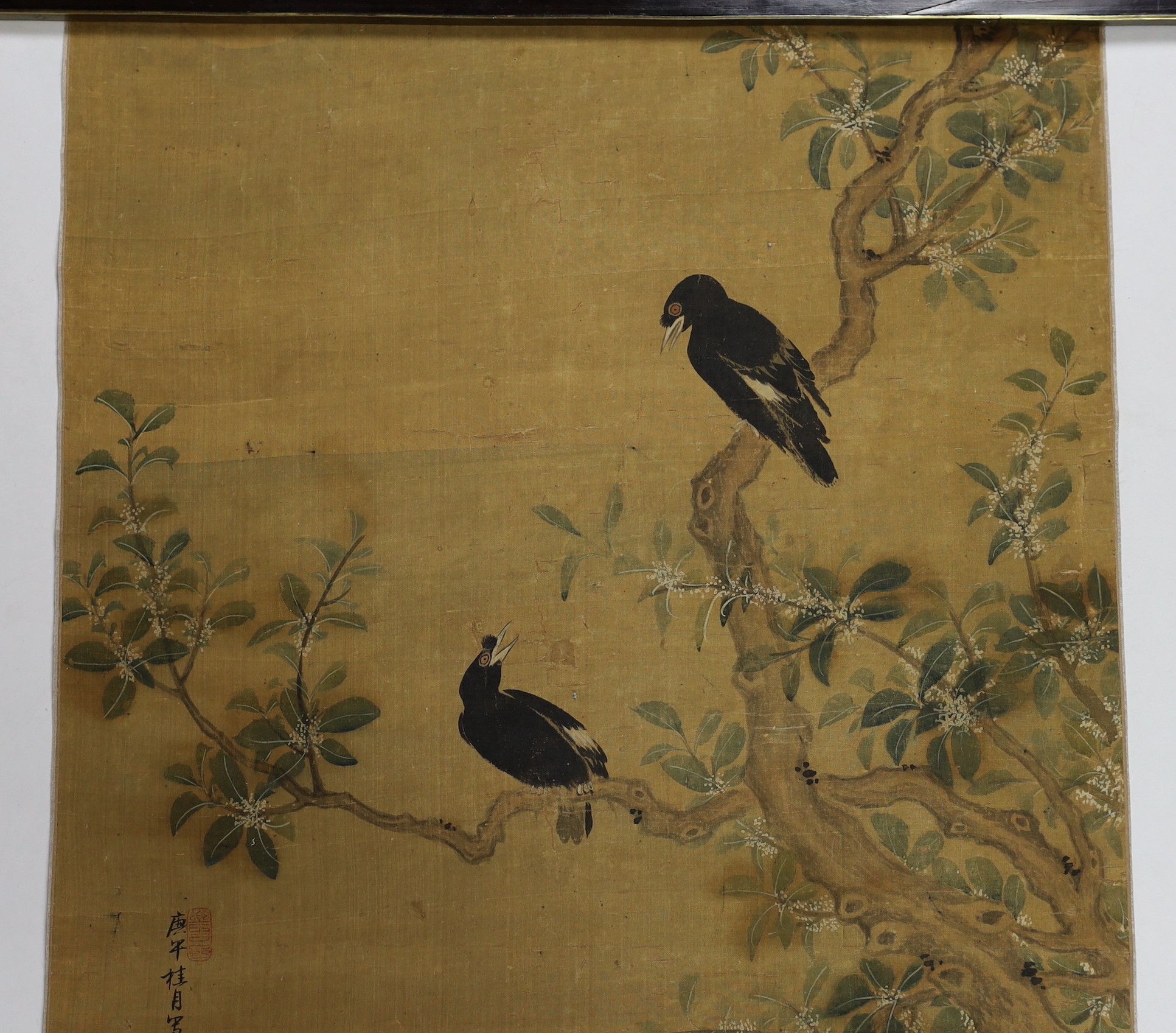 A Chinese scroll painting on silk of birds, rockwork and plants overhanging a pond, 19th century, image 164.5cm x 50.5cm